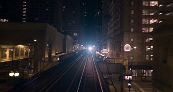 Movie still from “The Christmas Chronicles” (2018), directed by Clay Kaytis – A view of a train track at night with cars on the tracks; Extreme Wide shot, High angle