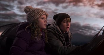 Movie still from “The Christmas Chronicles” (2018), directed by Clay Kaytis – A girl and a boy sitting next to each other; Medium shot, Low angle