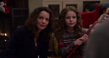 Movie still from “The Christmas Chronicles” (2018), directed by Clay Kaytis – A woman and a young girl sitting next to each other; Medium shot, Over the shoulder angle