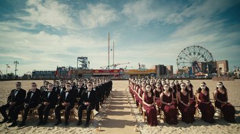Movie still from “Mr. Robot” (2015), created by Sam Esmail – A group of people sitting on chairs in front of a ferris wheel; Extreme Wide shot, High angle