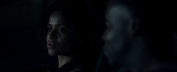 Movie still from “The Cloverfield Paradox” (2018), directed by Julius Onah – A woman looking at the camera while a man looks at her; Close Up shot, Over the shoulder angle