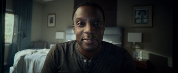 Movie still from “The Cloverfield Paradox” (2018), directed by Julius Onah – A man's face in a dark room; Close Up shot, Low angle