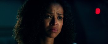 Movie still from “The Cloverfield Paradox” (2018), directed by Julius Onah – A person with curly black hair; Close Up shot, Low angle