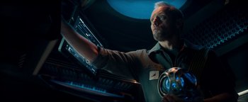 Movie still from “The Cloverfield Paradox” (2018), directed by Julius Onah – A man holding a beer in his hand; Close Up shot, Overhead angle