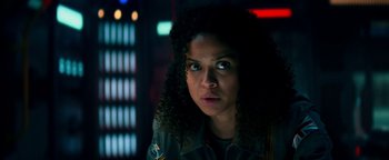 Movie still from “The Cloverfield Paradox” (2018), directed by Julius Onah – A person with curly black hair; Close Up shot, Low angle