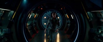 Movie still from “The Cloverfield Paradox” (2018), directed by Julius Onah – A man walking down a hallway in front of a door; Wide shot, Low angle
