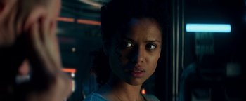 Movie still from “The Cloverfield Paradox” (2018), directed by Julius Onah – A person wearing a necklace; Close Up shot, Low angle