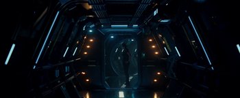Movie still from “The Cloverfield Paradox” (2018), directed by Julius Onah – A man standing inside of a spaceship looking into a window; Wide shot, High angle