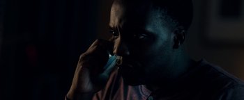 Movie still from “The Cloverfield Paradox” (2018), directed by Julius Onah – A person talking on a cell phone; Close Up shot, Low angle