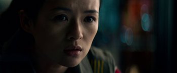 Movie still from “The Cloverfield Paradox” (2018), directed by Julius Onah – A woman's face in a dark room; Close Up shot, Over the shoulder angle