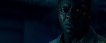 Movie still from “The Cloverfield Paradox” (2018), directed by Julius Onah – A man's face in the dark; Close Up shot, Low angle