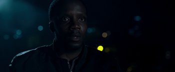 Movie still from “The Cloverfield Paradox” (2018), directed by Julius Onah – A person looking at the camera; Close Up shot, Over the shoulder angle