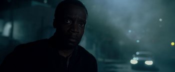 Movie still from “The Cloverfield Paradox” (2018), directed by Julius Onah – A man with a black shirt is looking into the distance; Close Up shot, Low angle