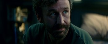 Movie still from “The Cloverfield Paradox” (2018), directed by Julius Onah – A person with a beard looking to his left; Close Up shot, Over the shoulder angle