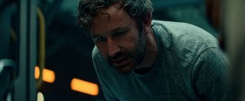 Movie still from “The Cloverfield Paradox” (2018), directed by Julius Onah – A person with curly hair and a beard; Close Up shot, Over the shoulder angle