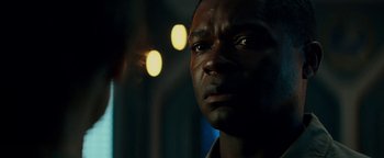 Movie still from “The Cloverfield Paradox” (2018), directed by Julius Onah – A man's face in the dark; Close Up shot, Over the shoulder angle