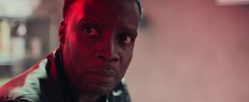 Movie still from “The Cloverfield Paradox” (2018), directed by Julius Onah – A man's face in a red light; Close Up shot, Over the shoulder angle