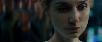 Movie still from “The Cloverfield Paradox” (2018), directed by Julius Onah – A woman's face in a dark room; Extreme Close Up shot, Over the shoulder angle