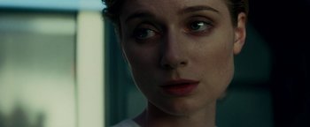 Movie still from “The Cloverfield Paradox” (2018), directed by Julius Onah – A woman's face in a dark room; Close Up shot, Over the shoulder angle