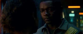 Movie still from “The Cloverfield Paradox” (2018), directed by Julius Onah – A man looking at another man in a dark room; Close Up shot, Over the shoulder angle