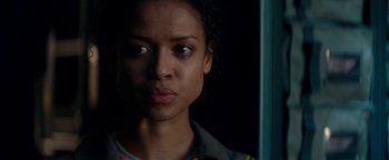 Movie still from “The Cloverfield Paradox” (2018), directed by Julius Onah – A young woman is looking at the camera; Close Up shot, Low angle