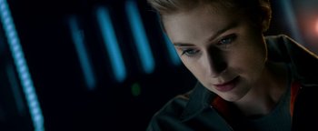 Movie still from “The Cloverfield Paradox” (2018), directed by Julius Onah – A person with short blonde hair; Close Up shot, Over the shoulder angle
