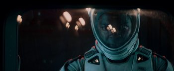 Movie still from “The Cloverfield Paradox” (2018), directed by Julius Onah – A man in a spacesuit is looking at the camera; Close Up shot, Overhead angle