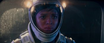 Movie still from “The Cloverfield Paradox” (2018), directed by Julius Onah – A man in a spacesuit with a tear in his eye; Close Up shot, Over the shoulder angle