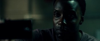 Movie still from “The Cloverfield Paradox” (2018), directed by Julius Onah – A man's face in the dark; Close Up shot, Low angle