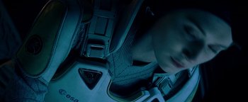 Movie still from “The Cloverfield Paradox” (2018), directed by Julius Onah – A person sitting in a car seat at night; Close Up shot, Overhead angle