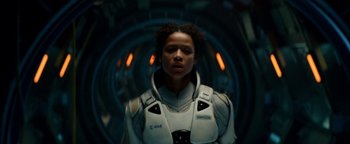 Movie still from “The Cloverfield Paradox” (2018), directed by Julius Onah – A woman in a space suit standing in front of a tunnel; Close Up shot, Low angle