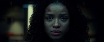 Movie still from “The Cloverfield Paradox” (2018), directed by Julius Onah – A person's face in a dark room; Close Up shot, Low angle
