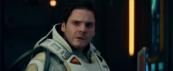Movie still from “The Cloverfield Paradox” (2018), directed by Julius Onah – A person wearing a suit and a helmet; Close Up shot, Over the shoulder angle