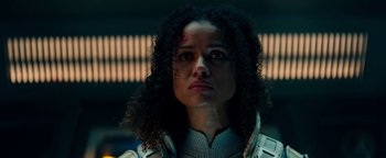 Movie still from “The Cloverfield Paradox” (2018), directed by Julius Onah – A woman that is looking at the camera; Close Up shot, Low angle
