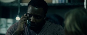 Movie still from “The Cloverfield Paradox” (2018), directed by Julius Onah – A person sitting in front of a window; Close Up shot, High angle