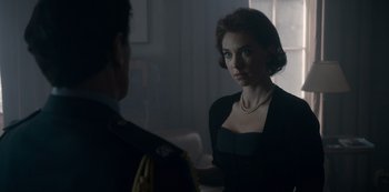 Movie still from “The Crown” (2016), created by Peter Morgan – A man and a woman are looking at one another; Medium shot, Over the shoulder angle