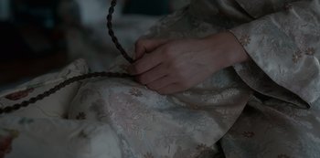 Movie still from “The Crown” (2016), created by Peter Morgan – A person is holding a piece of fabric; Extreme Close Up shot, High angle