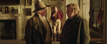 Movie still from “Mr. Turner” (2014), directed by Mike Leigh – Two men are talking to each other in a room; Medium shot, Over the shoulder angle
