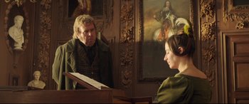 Movie still from “Mr. Turner” (2014), directed by Mike Leigh – A man and a woman sitting in front of a piano in a room; Medium shot, Over the shoulder angle