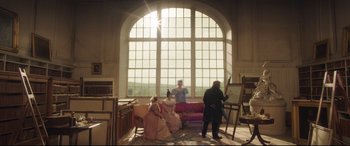 Movie still from “Mr. Turner” (2014), directed by Mike Leigh – A group of people sitting on a couch in front of a window; Wide shot, Low angle