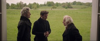 Movie still from “Mr. Turner” (2014), directed by Mike Leigh – Three people in a field talking to each other; Medium shot, Over the shoulder angle