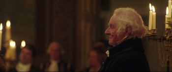 Movie still from “Mr. Turner” (2014), directed by Mike Leigh – An older man in a black jacket looking to his left; Close Up shot, Over the shoulder angle