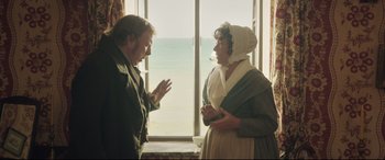 Movie still from “Mr. Turner” (2014), directed by Mike Leigh – A man and a woman standing in front of a window; Medium shot, Over the shoulder angle