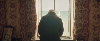Movie still from “Mr. Turner” (2014), directed by Mike Leigh – An older man looking out of a window at the ocean; Medium shot, Over the shoulder angle