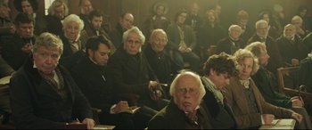 Movie still from “Mr. Turner” (2014), directed by Mike Leigh – A group of people sitting in a room; Medium shot, High angle