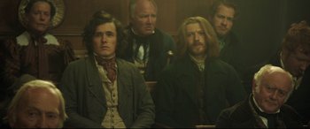 Movie still from “Mr. Turner” (2014), directed by Mike Leigh – A group of people sitting in a room; Medium shot, High angle