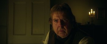 Movie still from “Mr. Turner” (2014), directed by Mike Leigh – An older man with a frown on his face; Close Up shot, Over the shoulder angle