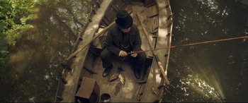Movie still from “Mr. Turner” (2014), directed by Mike Leigh – A man sitting in a boat on the water; Wide shot, Overhead angle