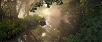 Movie still from “Mr. Turner” (2014), directed by Mike Leigh – A person sitting in a boat on a body of water surrounded by trees; Extreme Wide shot, High angle