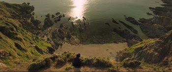 Movie still from “Mr. Turner” (2014), directed by Mike Leigh – A person sitting on the shore of a body of water; Extreme Wide shot, High angle